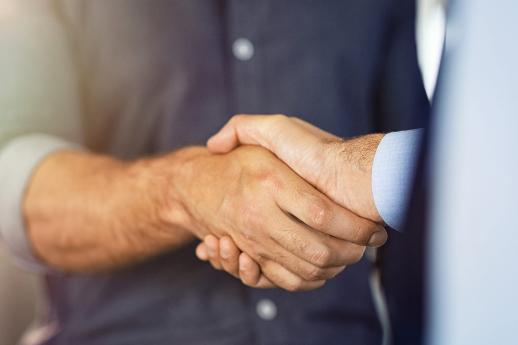 Close up of friendly handshake of business people