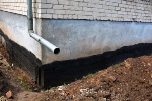 Picture of a drainage pipe in the exterior area of a home.