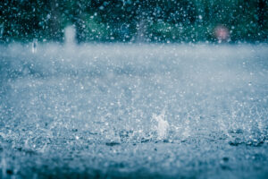 Picture of rain splashing on a puddle outside.