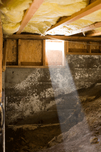 A ray of sun slanting into a crawlspace 